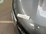 a sticker on the hood of a car with a name on it