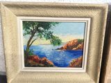 painting of a tree and a body of water in a picture frame