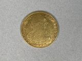 a gold coin on a white surface