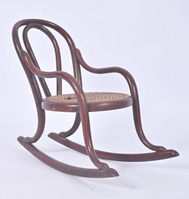 a wooden rocking chair with a wicker seat on a white background