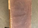 an old book that is laying on the floor