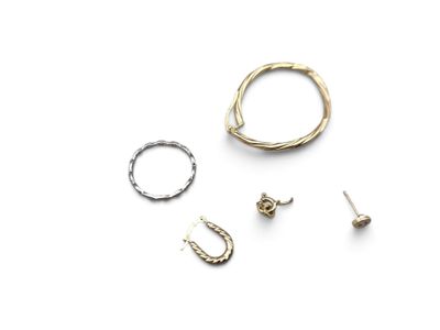 three different rings and earrings on a white surface