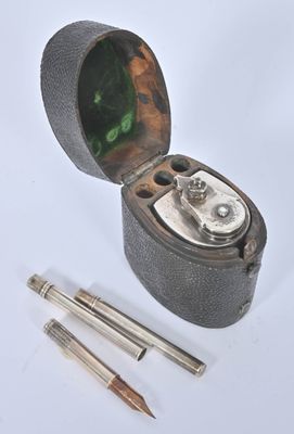 a small metal box with a pen and a pencil in it