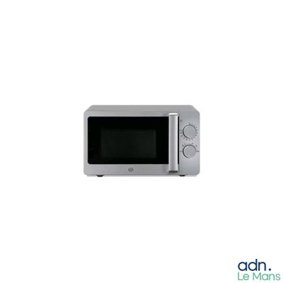 a silver microwave oven sitting on a white surface