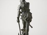 an old bronze statue of a man with a sword and shield