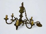 a brass chandelier with five candles on it