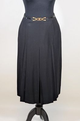 a black dress with a gold belt on a mannequin mannequin