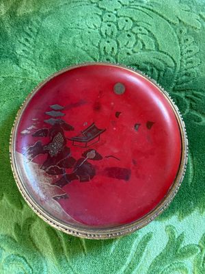 a picture of a red button with a dragon on it