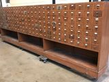 a wooden cabinet with a lot of drawers on it