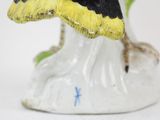 a figurine of a bird sitting on top of a table