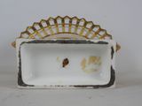 a white and gold plate with a gold crown on it