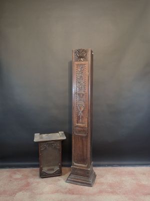a tall wooden clock sitting next to a small wooden box