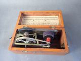 a small wooden box with a sewing machine inside of it