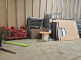 a forklift in the middle of a room with a lot of boxes on the floor