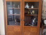 a wooden cabinet with glass doors in a room
