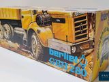 a box with a picture of a yellow dump truck on it