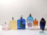 several different types of perfume bottles lined up on a white surface