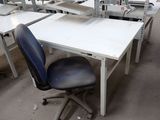 many desks and chairs in a room with a lot of shelves