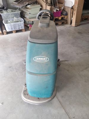 an image of a blue machine is sitting in a garage