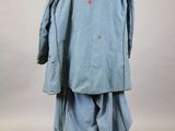 an image of a man in a blue coat and black boots
