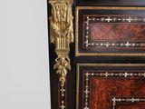 an antique chest of drawers with a marble top and gold trimming