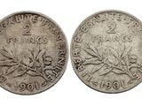une pièce d'argent sur laquelle figure une branche d'olivier