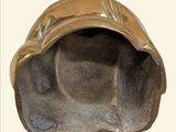 a bronze sculpture of a shell on a white background