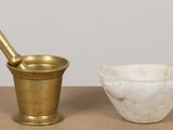 a mortar and a bowl sitting on a table