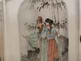 three glass snuff bottles with asian paintings on them sitting on a table