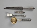a knife, spoon, and spoon rest on a table