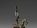 statue of a man riding a horse with a sword on top of it