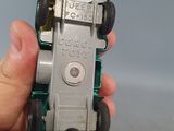 a person holding a toy car in their hand