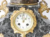a statue of a woman sitting on top of a clock