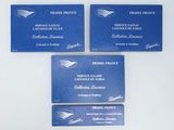 three blue business cards sitting on top of each other on a table