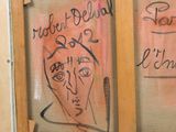 a drawing of a woman ' s face on the glass of a door
