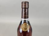 an image of a bottle of brandy sitting on a table
