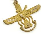 an image of a gold necklace with an eagle and a guitar