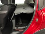 the interior of a red car with the back seat folded open
