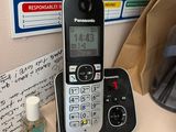 a phone that is sitting on a table next to a bag