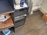 a metal shelf with a bottle of water on top of it