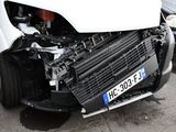 a white car that has been badly damaged by the front end of it