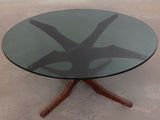 a glass table with a wooden base and a glass top