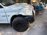 a white truck that has been damaged and is parked on the side of the road