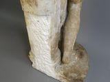 marble statue of a man with a hat and a bag