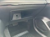 the interior of a car with the door open and a paper roll sticking out of it