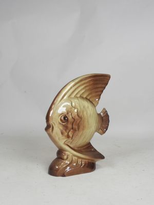 a figurine of a fish on a white background