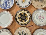 many plates that are sitting on a wooden table