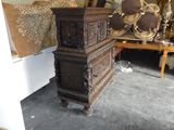 a tall wooden chest sitting in a room with a bed
