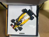 a model of a yellow race car in a box