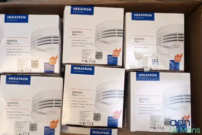 several boxes of smoke detectors are stacked on top of each other